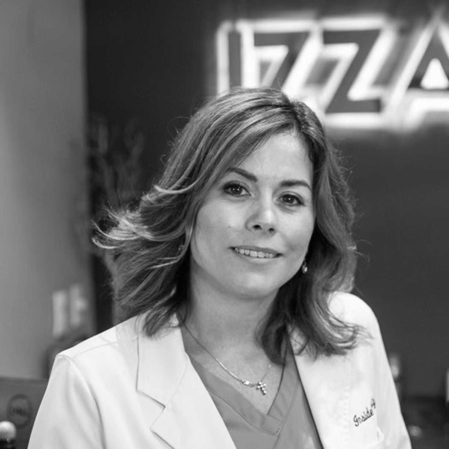 Portrait of Malissa, a professional stylist at Izzazu Salon, showcasing their expertise and style.