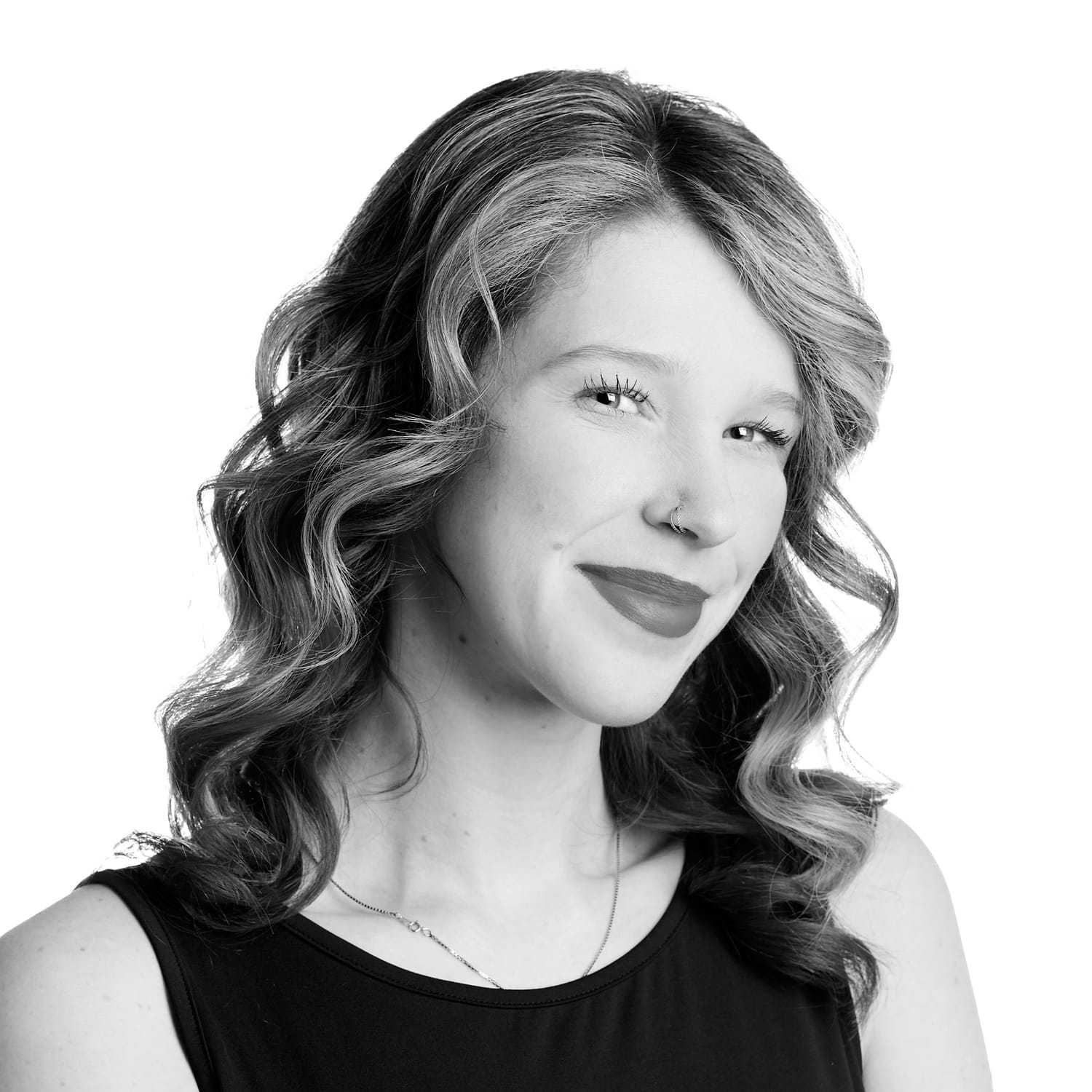 Portrait of Kayla, a professional stylist at Izzazu Salon, showcasing their expertise and style.