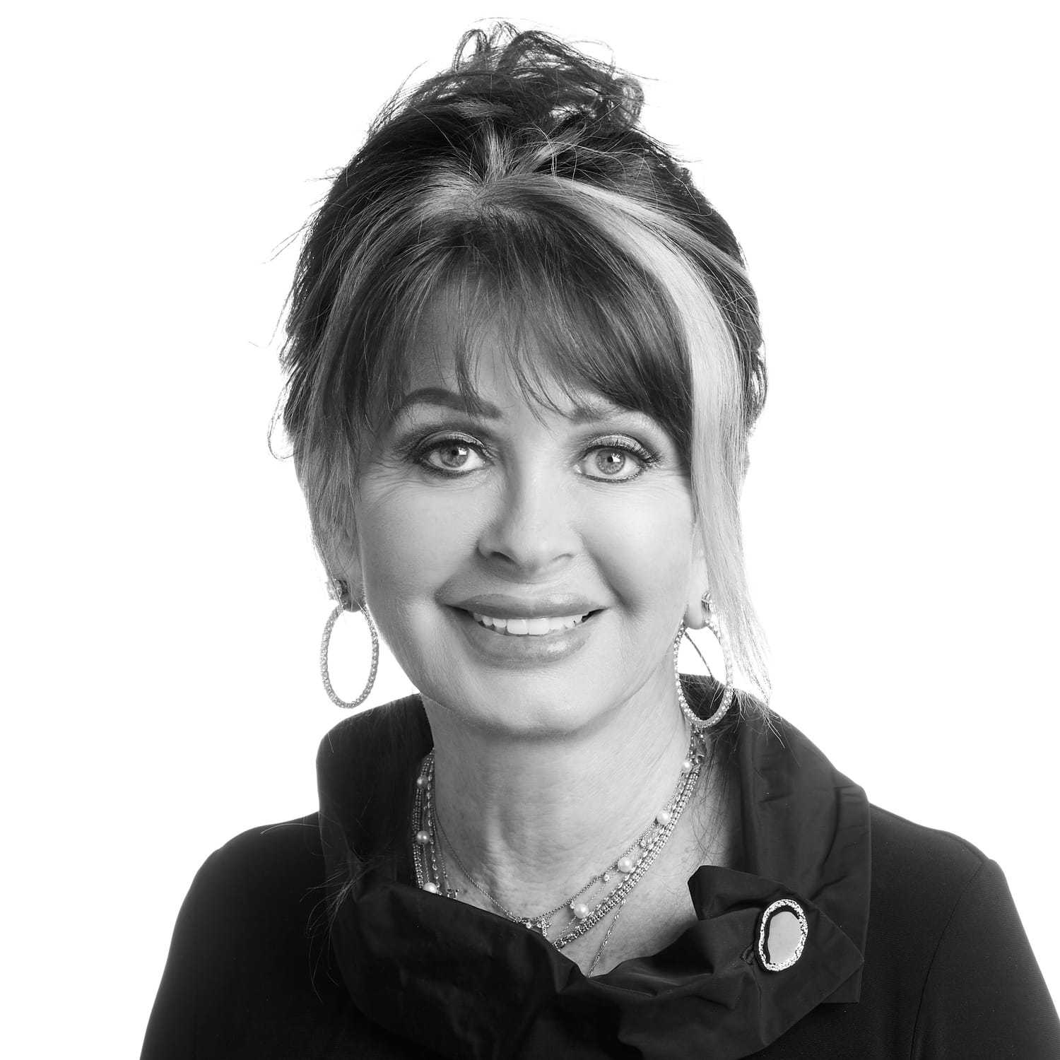 Portrait of Donna, a professional stylist at Izzazu Salon, showcasing their expertise and style.