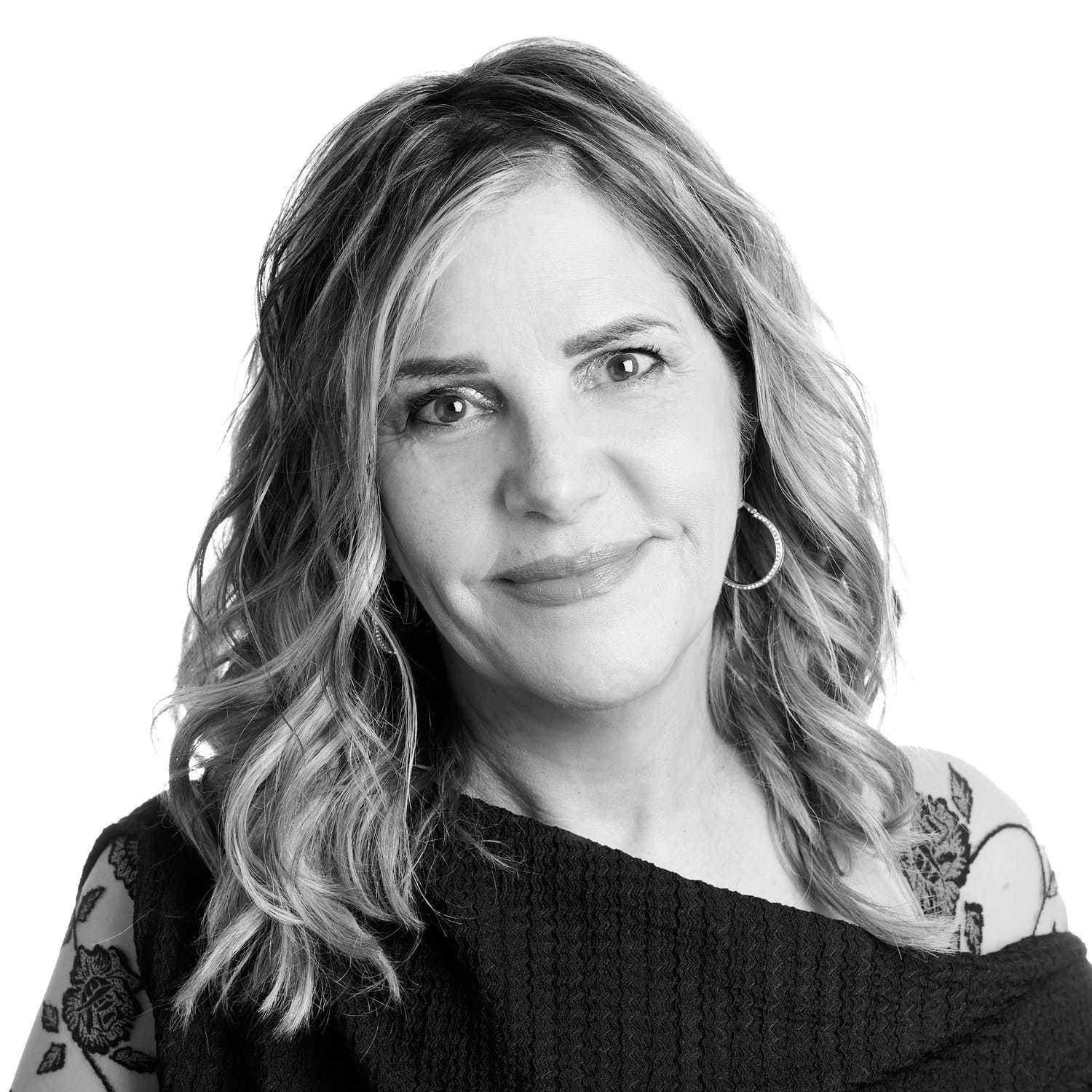 Portrait of Gigi, a professional stylist at Izzazu Salon, showcasing their expertise and style.