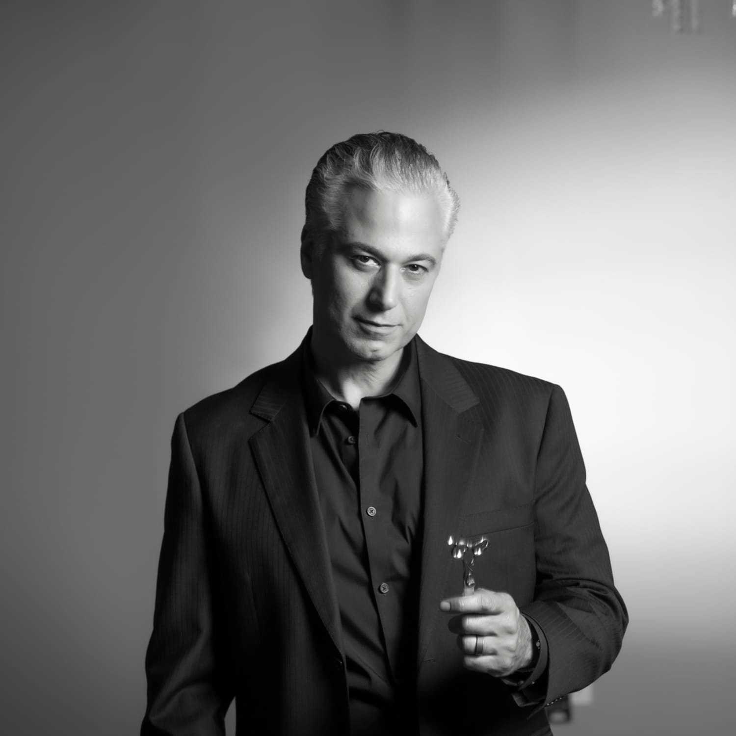 Portrait of Emilio Cornacchione, a professional stylist at Izzazu Salon, showcasing their expertise and style.