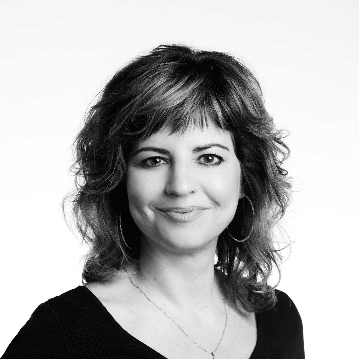 Portrait of Megan, a professional stylist at Izzazu Salon, showcasing their expertise and style.